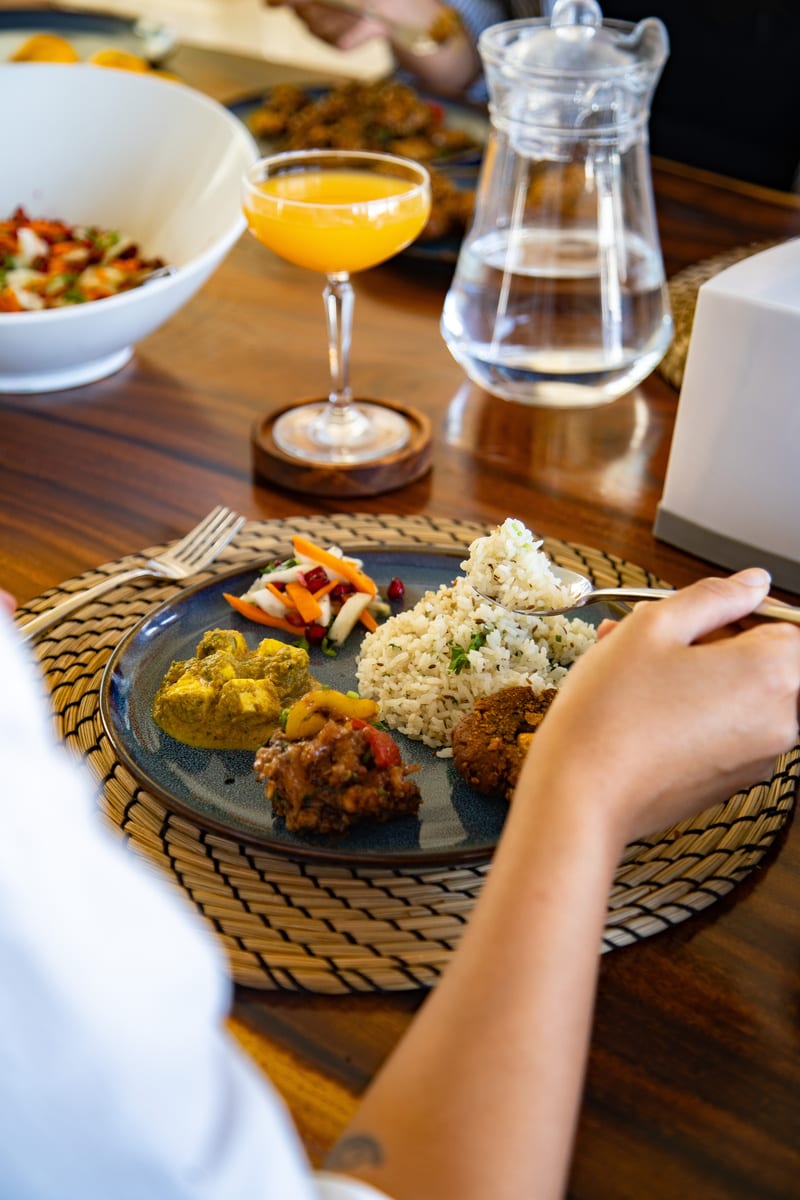 A plated meal and fresh juice served at Emerald Lotus Villas